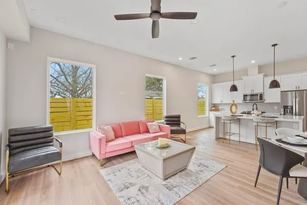 a living room with kitchen island furniture and a window