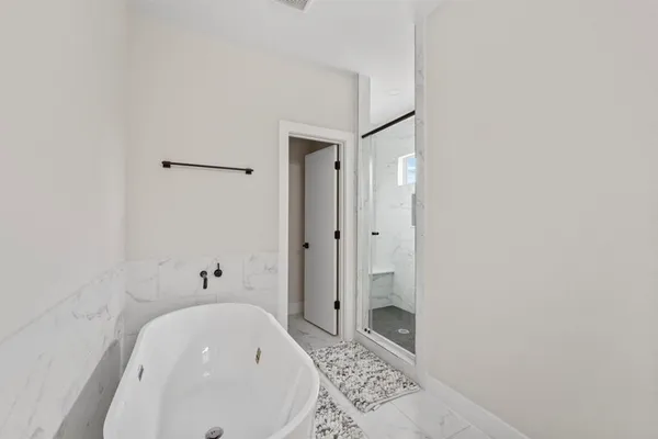 a bathroom with a bathtub and shower