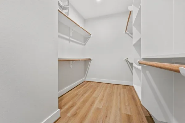 a view of a room with wooden floor and white walls