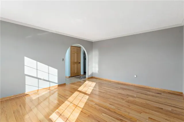 a view of a room with wooden floor and white walls