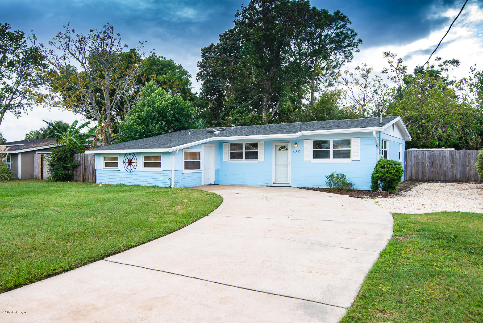 480 Irex Road Atlantic Beach, FL 32233 - Photo 1 of 26 a view of a yard in front of a house with plants and large tree
