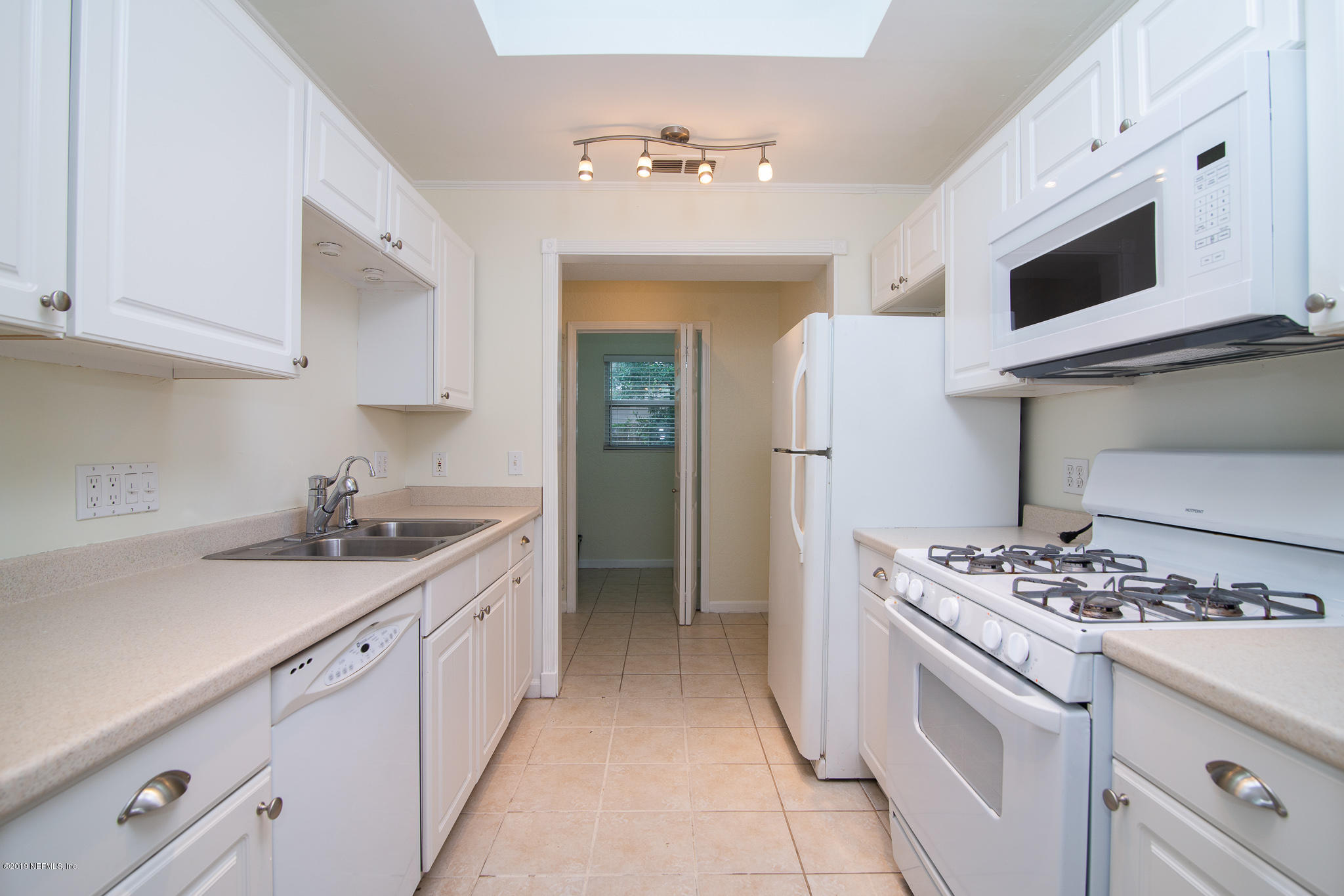 480 Irex Road Atlantic Beach, FL 32233 - Photo 11 of 26 a kitchen with stainless steel appliances kitchen island granite countertop a sink stove and refrigerator