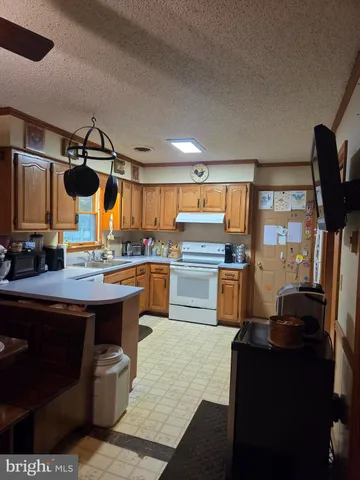 a kitchen with refrigerator and cabinets