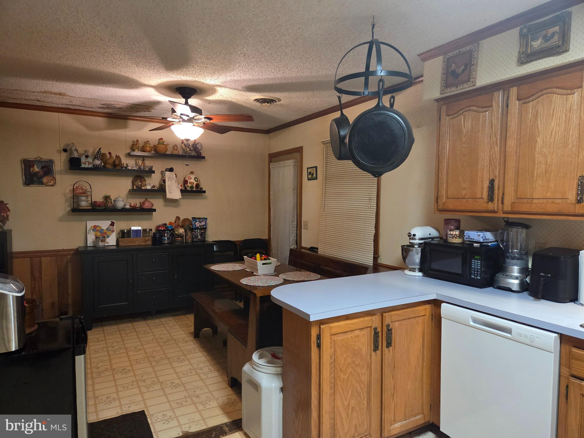21245 Tanyard Road Preston, MD 21655 - Photo 3 of 10 a kitchen with stainless steel appliances granite countertop a sink cabinets and wooden floor