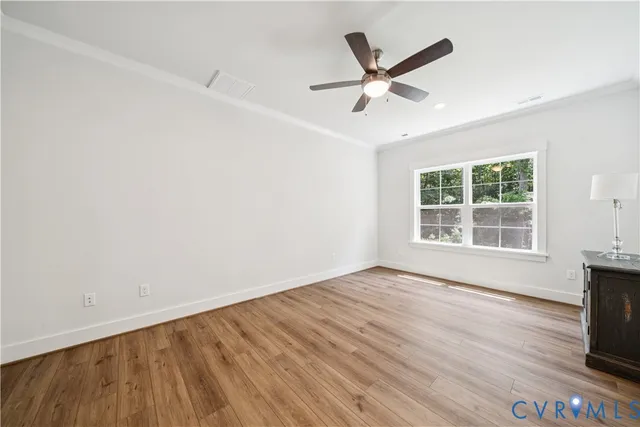 wooden floor in an empty room with a window