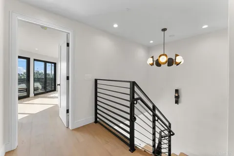 a bedroom with a large bed and a chandelier