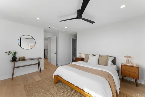 a bedroom with a bed and a painting on the wall