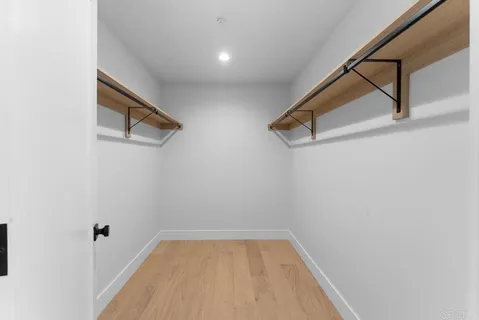 a view of room with stairs and wooden floor