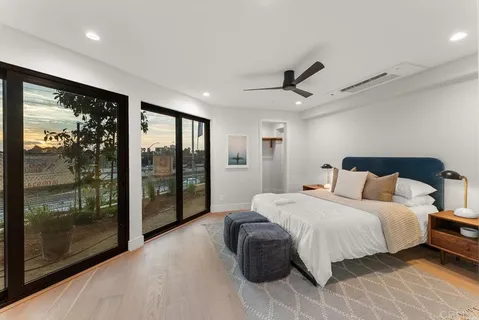 a bedroom with a large bed and a large window