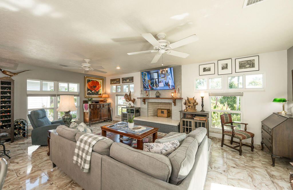 1407 Rose Street Key West, FL 33040 - Photo 13 of 74 a living room with furniture a fireplace and a flat screen tv