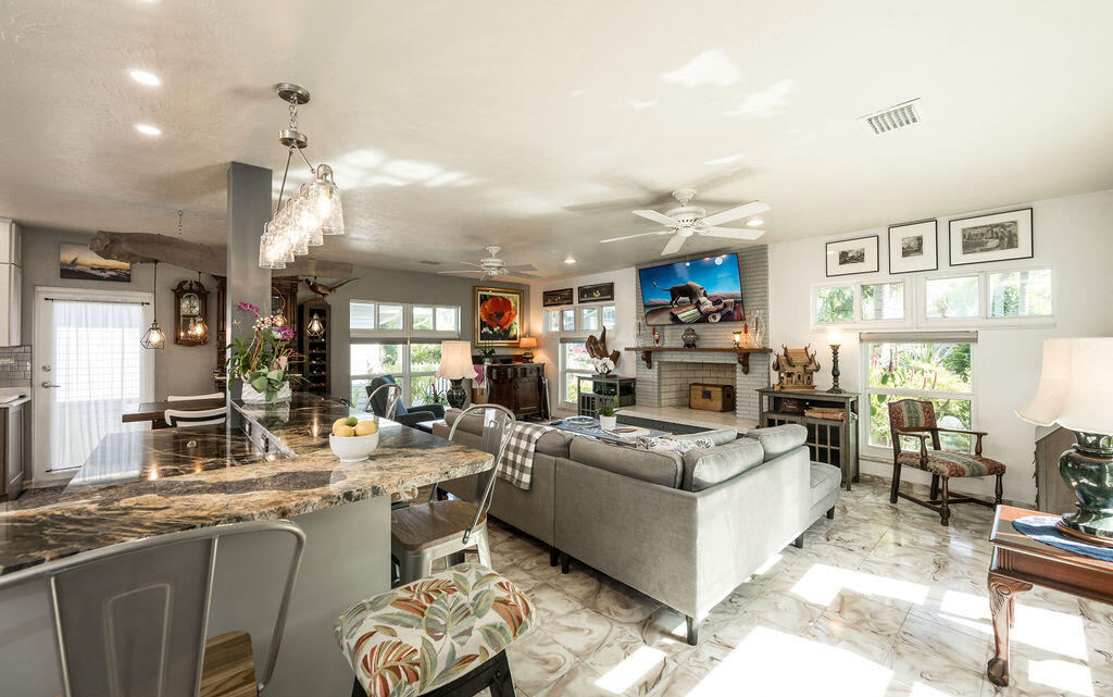 1407 Rose Street Key West, FL 33040 - Photo 15 of 74 a living room with furniture a rug and a chandelier