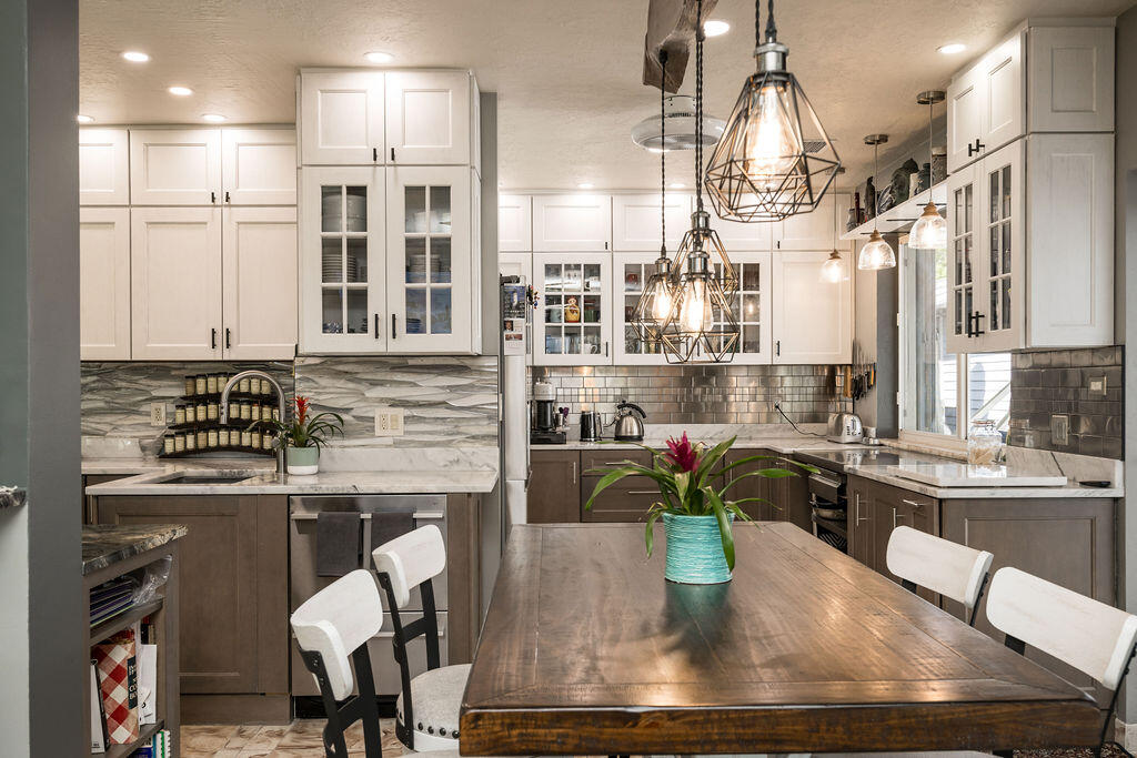 1407 Rose Street Key West, FL 33040 - Photo 24 of 74 a kitchen with kitchen island a stove a table and chairs in it