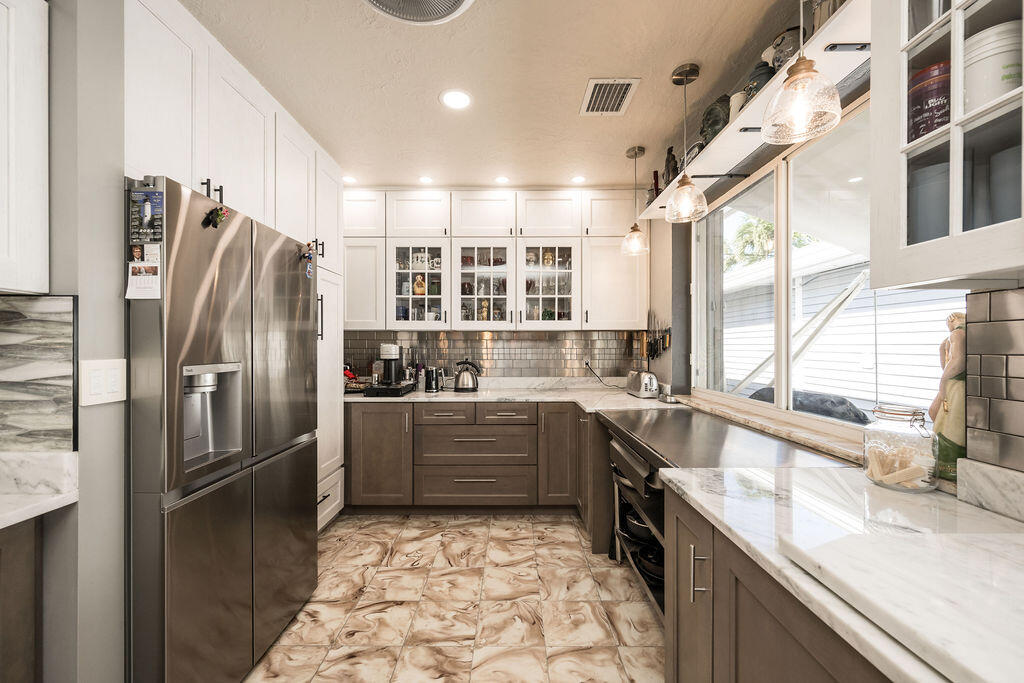 1407 Rose Street Key West, FL 33040 - Photo 26 of 74 a kitchen with stainless steel appliances granite countertop a sink stove and refrigerator