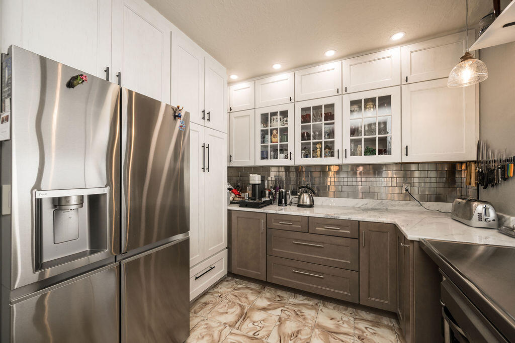 1407 Rose Street Key West, FL 33040 - Photo 30 of 74 a kitchen with stainless steel appliances granite countertop a refrigerator and a sink