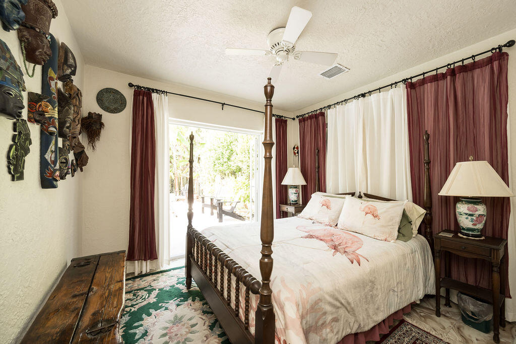 1407 Rose Street Key West, FL 33040 - Photo 45 of 74 a bedroom with a bed and a chandelier