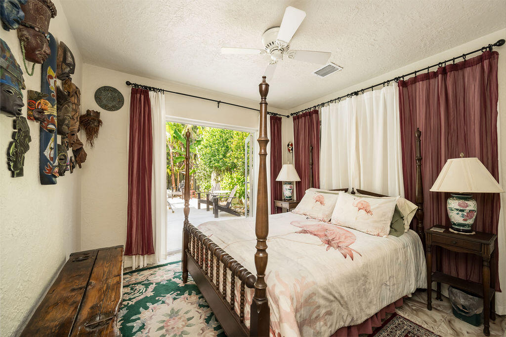 1407 Rose Street Key West, FL 33040 - Photo 47 of 74 a bedroom with a bed and a chandelier