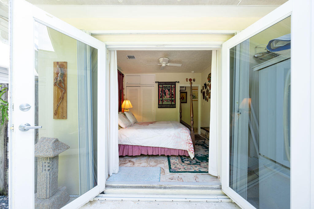 1407 Rose Street Key West, FL 33040 - Photo 48 of 74 a bedroom with a bed and a mirror