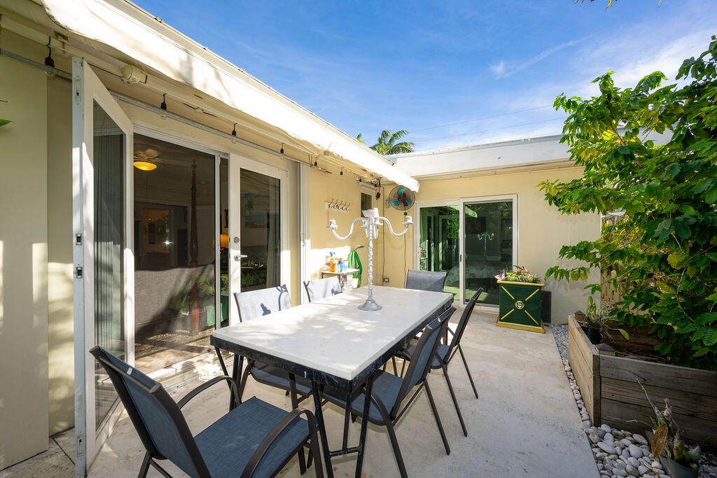 1407 Rose Street Key West, FL 33040 - Photo 67 of 74 a view of a patio with table and chairs and potted plants
