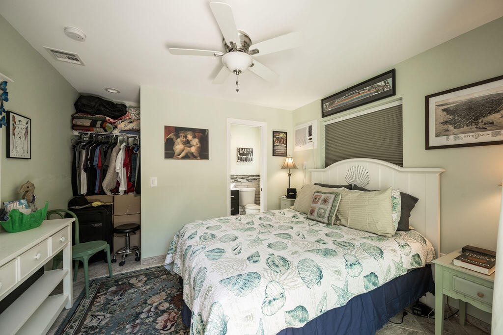 1407 Rose Street Key West, FL 33040 - Photo 70 of 74 a bedroom with a bed and a chandelier
