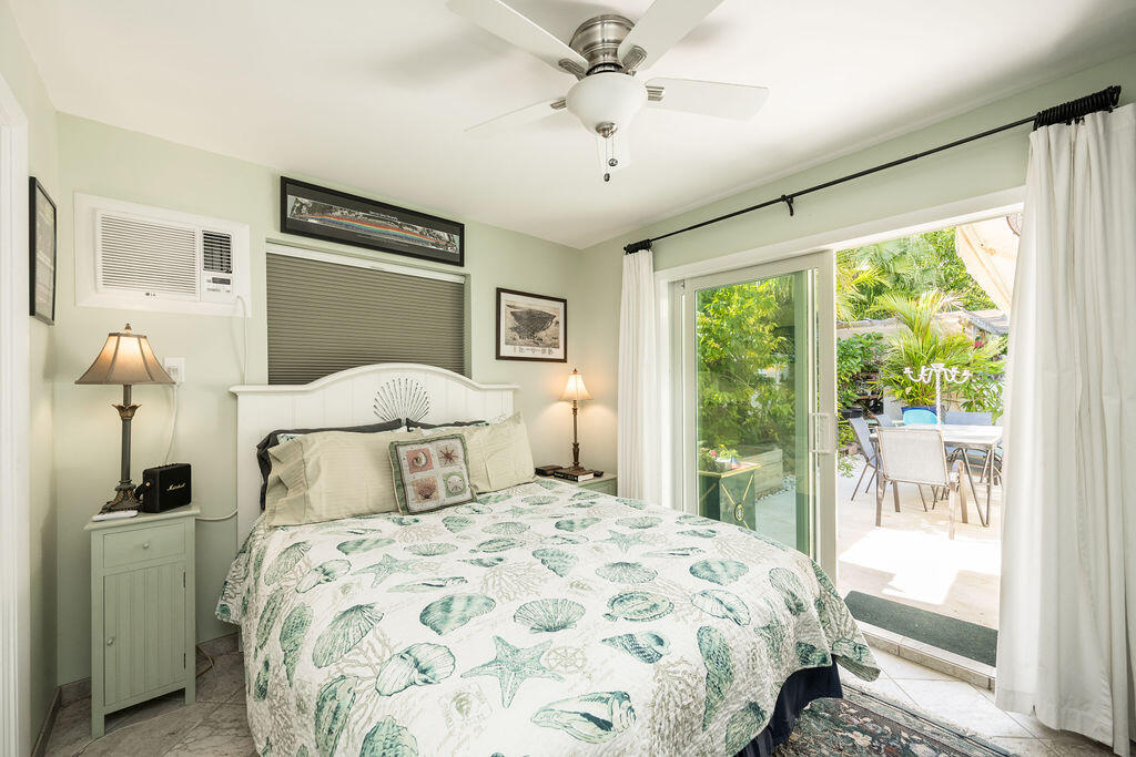 1407 Rose Street Key West, FL 33040 - Photo 71 of 74 a bedroom with a large bed and a window