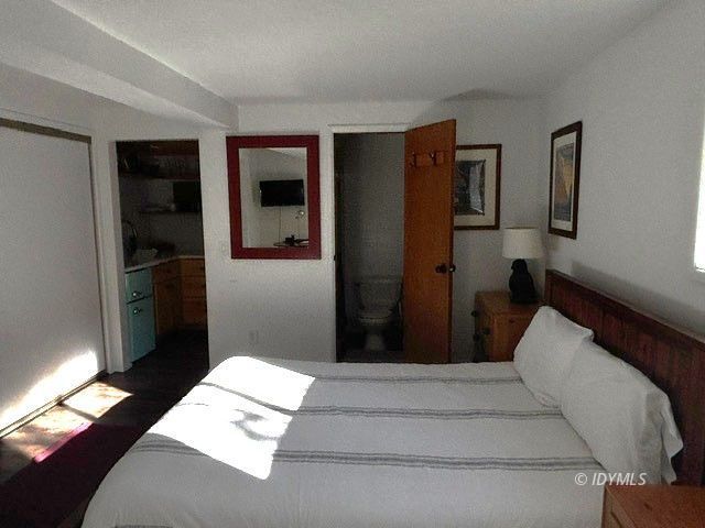 25405 Seneca Road Idyllwild, CA 92549 - Photo 22 of 27 a bedroom with a bed and a walk in closet