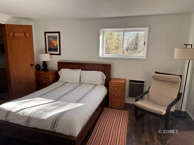25405 Seneca Road Idyllwild, CA 92549 - Photo 23 of 27 a bedroom with a bed and wooden floor