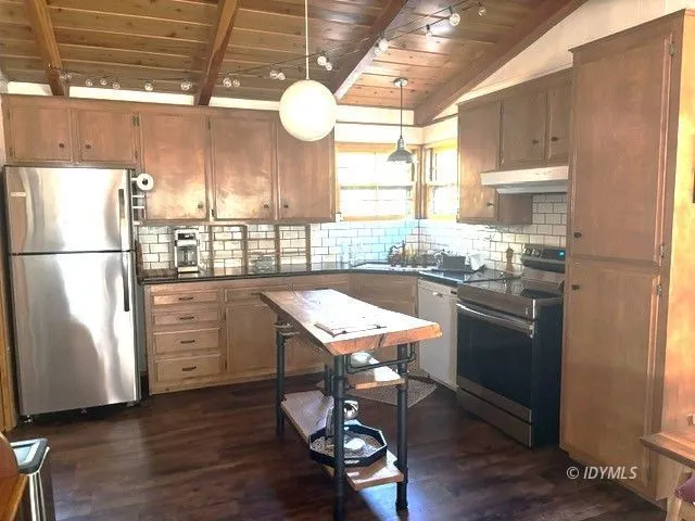 a kitchen with refrigerator cabinets and wooden floor
