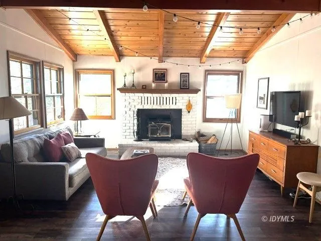 a living room with furniture a fireplace and a large window