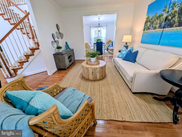 a living room with furniture and flowers