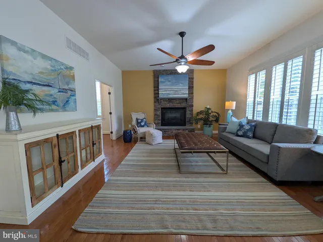 a living room with furniture dining area and a chandelier