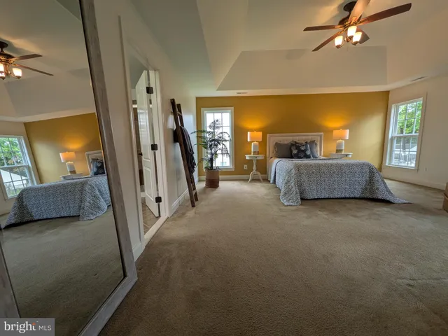 a bedroom with a bed and glass window