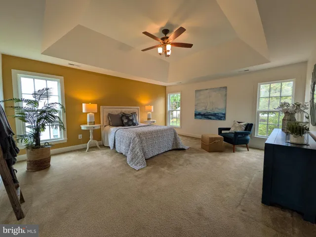 a bedroom with two beds and painting on the wall