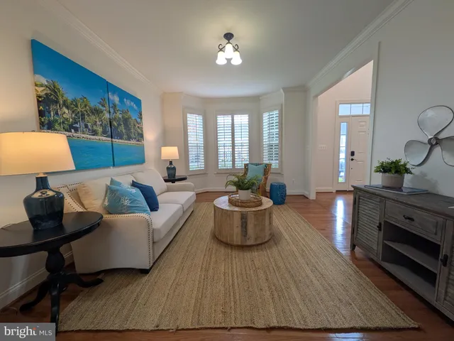 a living room with furniture and flowers