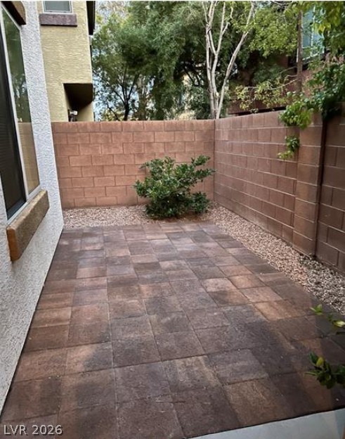 8937 Caledon Ridge Court Las Vegas, NV 89149 - Photo 2 of 2 A private backyard retreat features durable paver flooring, ideal for serene outdoor living.
