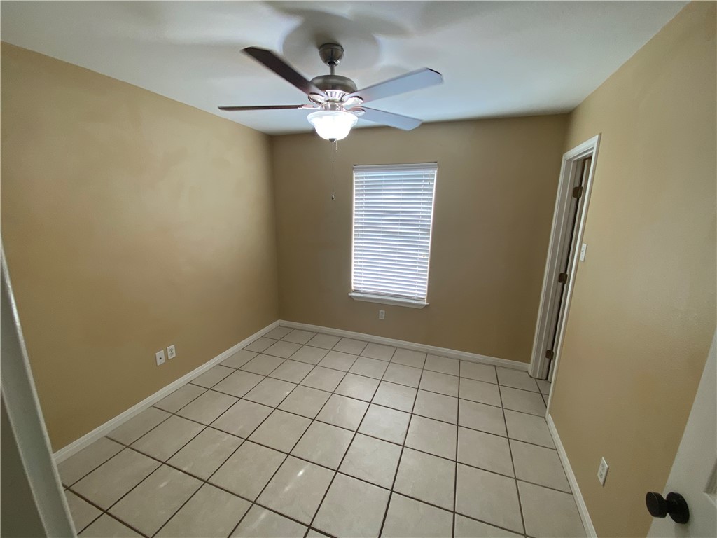 15410 Cruiser Street, Unit B Corpus Christi, TX 78418 - Photo 15 of 25 a view of an empty room and chandelier fan and window