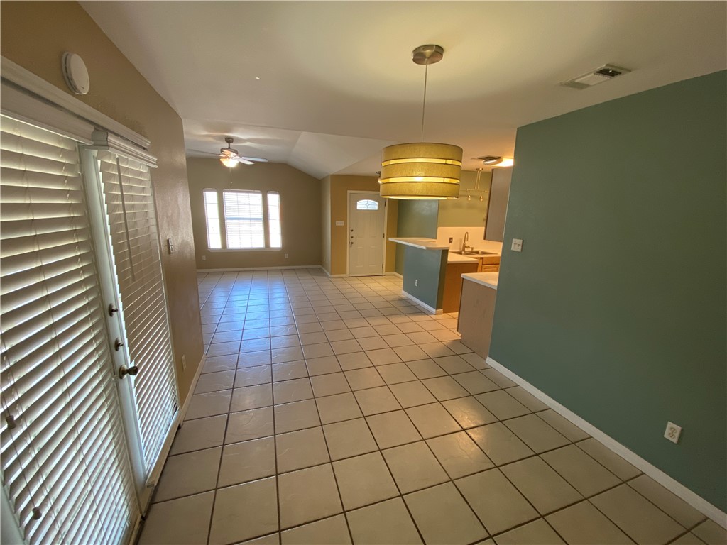 15410 Cruiser Street, Unit B Corpus Christi, TX 78418 - Photo 4 of 25 a view of a hallway to room with wooden floor