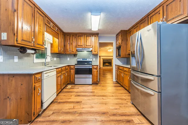a view of a kitchen with a stove cabinets and a kitchen view