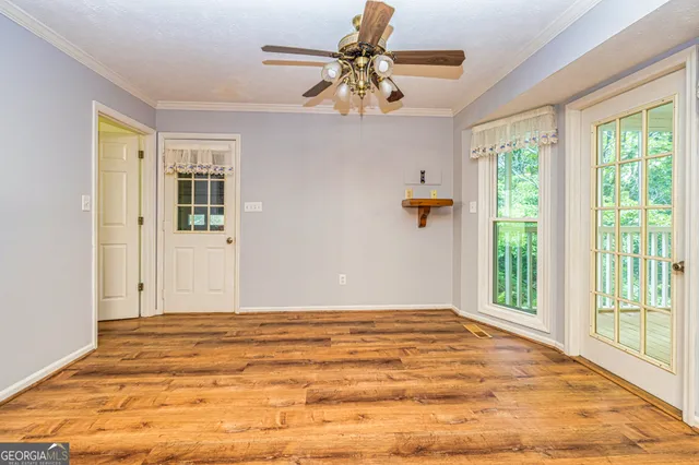 a view of a living room with wooden floor and a chandelier