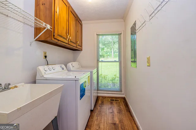 a view of a room with wooden floor