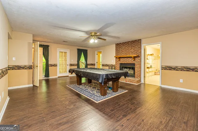 a yellow and red house with a tree in the background