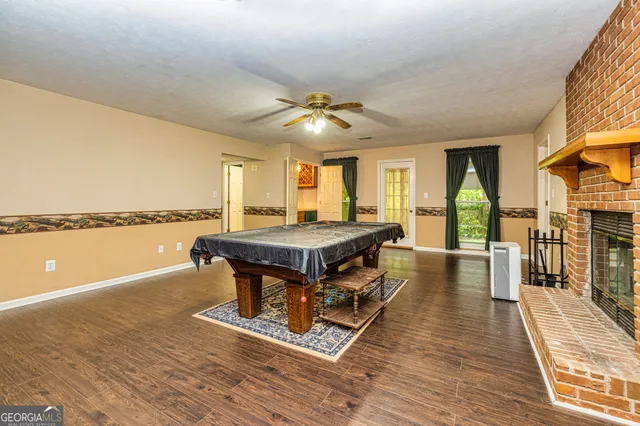 an aerial view of residential house with outdoor space and trees all around
