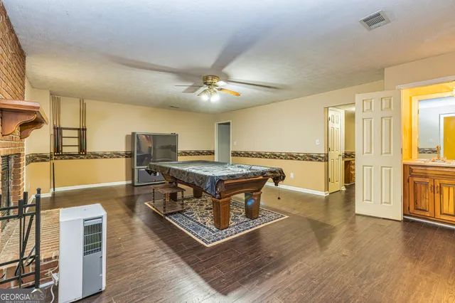 an aerial view of residential house with outdoor space and trees all around