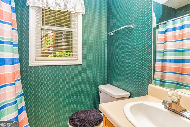 an aerial view of a house with a yard and lake view