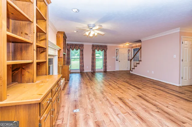 a view of a bathroom with a sink and wooden floor