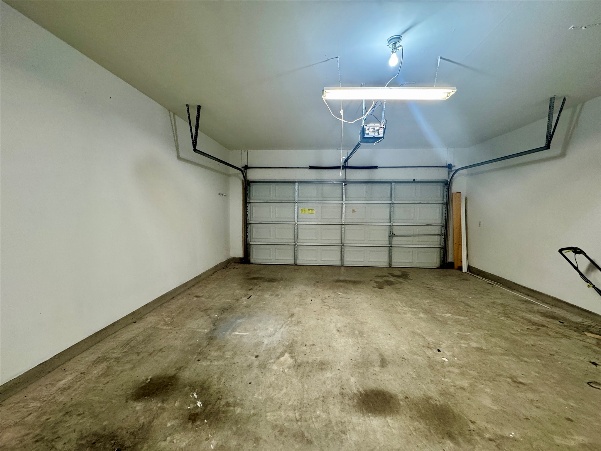 3640 Fossilwood Way Round Rock, TX 78681 - Photo 13 of 19 Garage with a garage door opener and baseboards