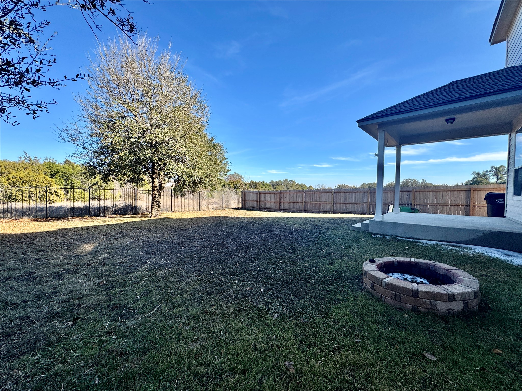 3640 Fossilwood Way Round Rock, TX 78681 - Photo 15 of 19 Fenced backyard with a patio and an outdoor fire pit