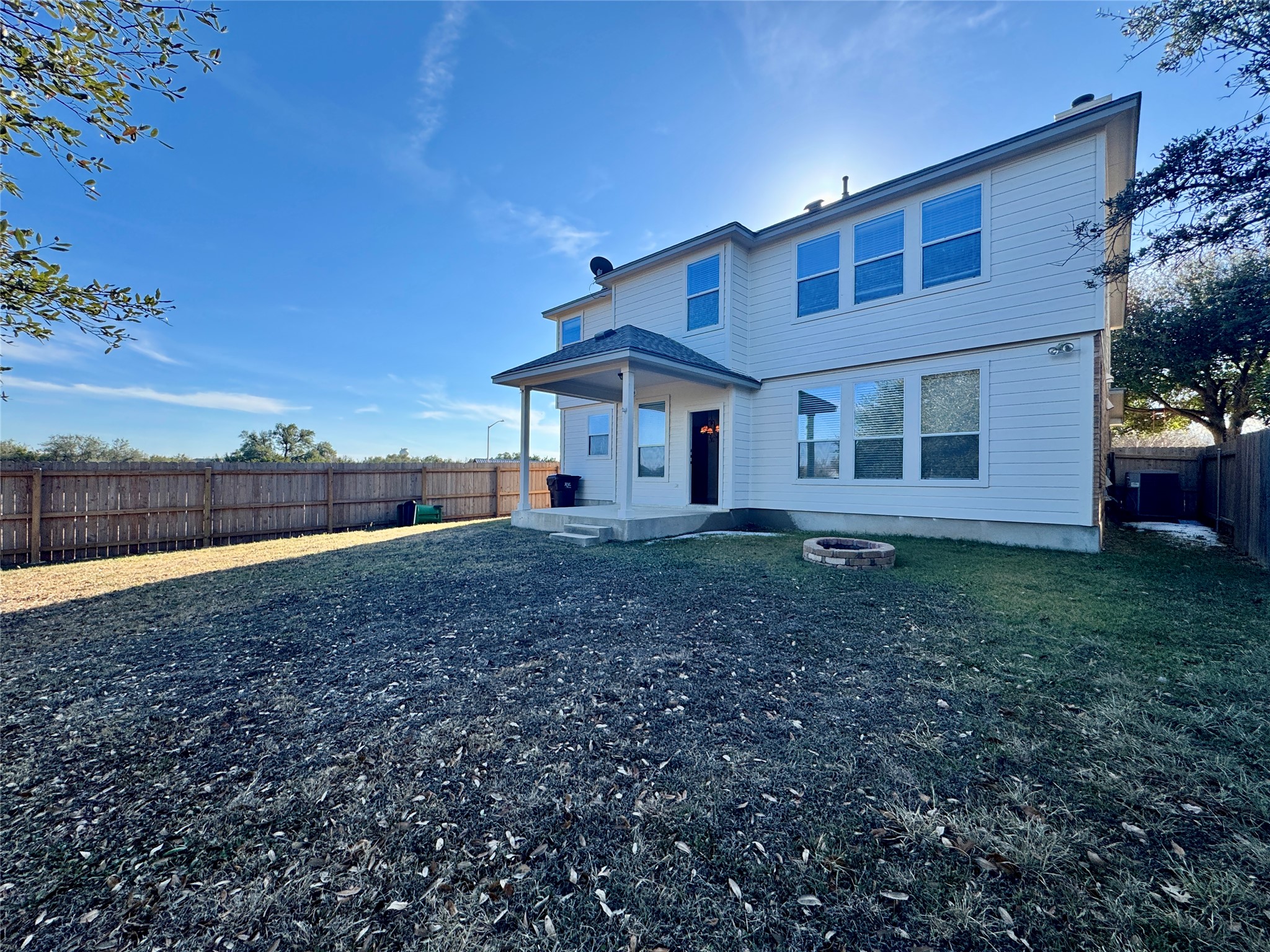 3640 Fossilwood Way Round Rock, TX 78681 - Photo 16 of 19 Back of house with a fenced backyard, a patio, and an outdoor fire pit