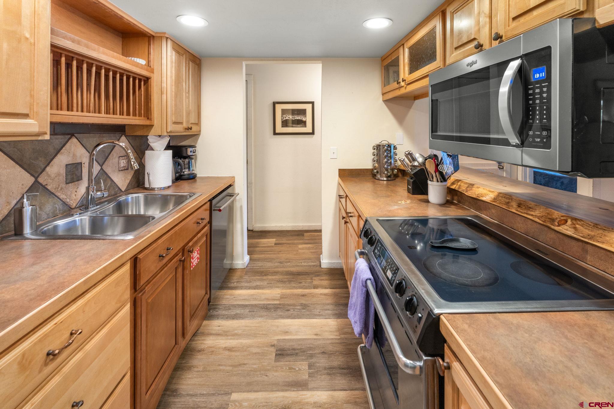 72 Hunter Hill Road, Unit I204 Crested Butte, CO 81225 - Photo 5 of 44 a kitchen with stainless steel appliances granite countertop a stove and a sink