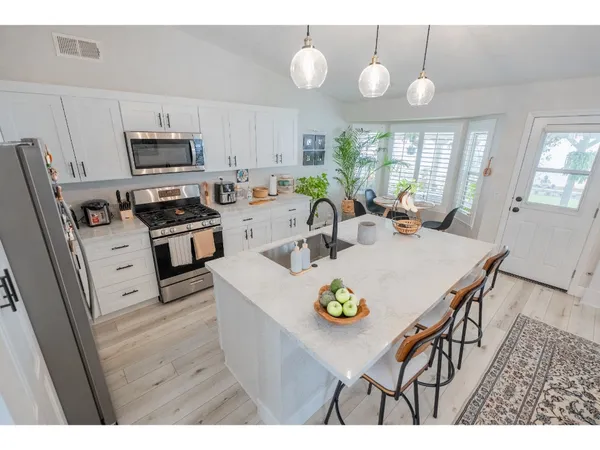 a kitchen with a dining table and chairs