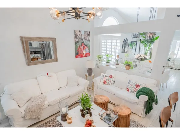 a living room with furniture and flowers